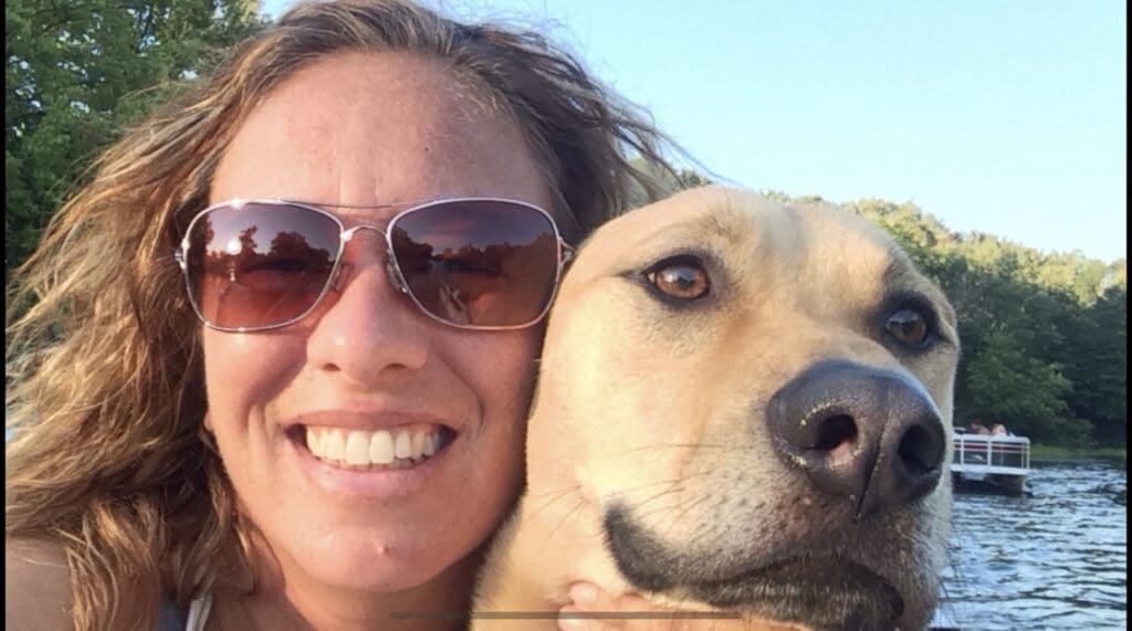 Melissa taking a close-up selfie with Mya, both smiling.